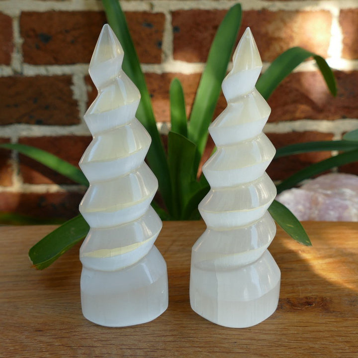 Selenite protects and shields a person or space from outside influences. Selenite is a crystallized form of Gypsum, which is used for good luck and protection. The powerful vibration of Selenite can clear, open, and activate the Crown and Higher Chakras and is excellent for all types of spiritual work. It's also excellent for clearing your aura and other crystals. Buddha Gear 